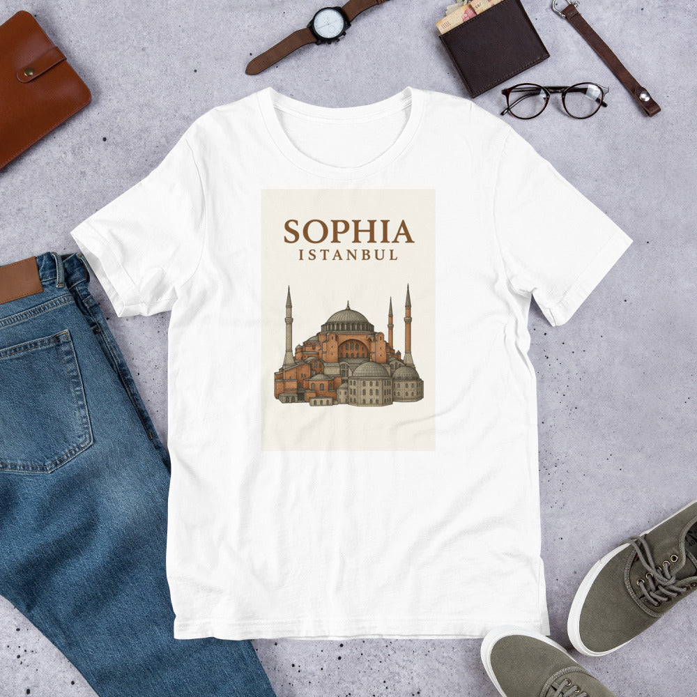 T-shirt blanc mettant en valeur une illustration chaleureuse et détaillée de la mosquée Sainte-Sophie (Ayasofya) d’Istanbul, sur fond de coucher de soleil aux teintes orangées. Le visuel est centré sur le torse et encadré par l’inscription élégante “SOPHIA ISTANBUL” en lettres majuscules. Un design raffiné et évocateur qui rend hommage à l’architecture ottomane et à l’âme d’Istanbul. Idéal pour les amoureux de culture, de spiritualité et d’histoire.
